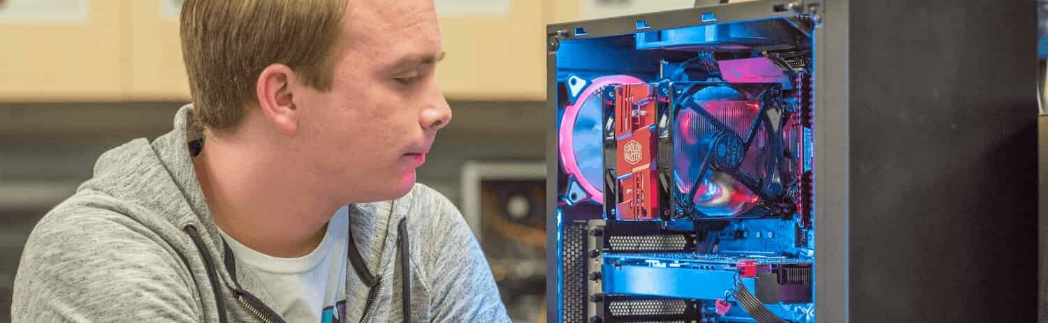 Student looks at glowing computer
